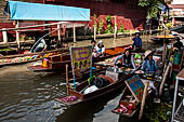 Thailand, Locals sell fruits, food and products at Damnoen Saduak floating market near Bangkok 